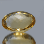 Natural oval cut citrine gemstone with yellow-orange color, 19.20 × 14.30 mm
