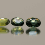Set of three green oval sapphires, heat-treated, Madagascar origin, total 2.86 carat, dimensions 7.13 × 5.09 × 3.04 mm, GFCO certified.