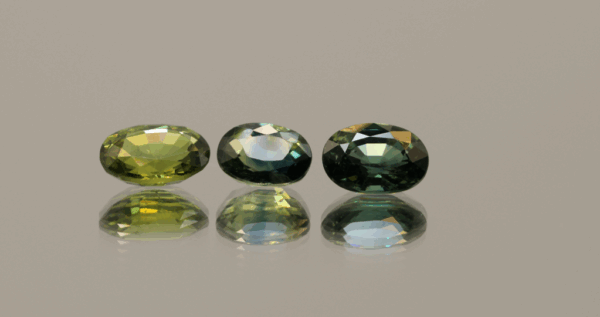 Set of three green oval sapphires, heat-treated, Madagascar origin, total 2.86 carat, dimensions 7.13 × 5.09 × 3.04 mm, GFCO certified.