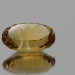 Natural oval cut citrine gemstone with yellow-orange color, 18.70 × 12.10 mm