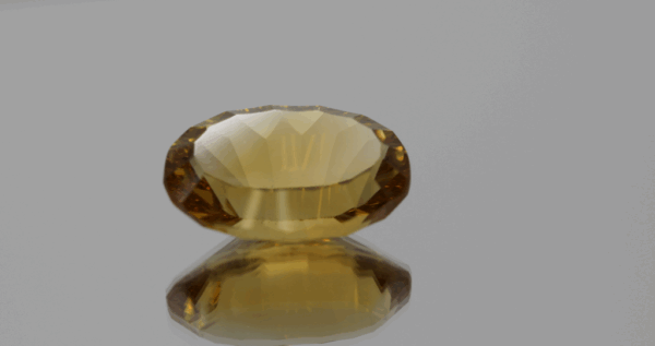 Natural oval cut citrine gemstone with yellow-orange color, 18.70 × 12.10 mm