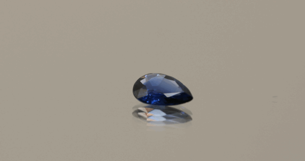 Royal blue pear-shaped sapphire, 0.55 carat, 7.05 × 5.00 × 2.00 mm, heat-treated, Madagascar origin, IGS certified.