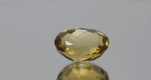 Natural oval cut citrine gemstone with yellow-orange color, 16.80 × 13.10 mm