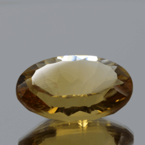 Natural oval cut citrine gemstone with yellow-orange color, 19.90 × 13.20 mm