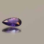 Violetish blue to purple pear-shaped, color change sapphire gemstone, 1.18 carat, 8.81 × 5.88 × 2.81 mm, no treatment, Madagascar origin, AIG certified.