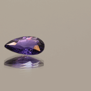 Violetish blue to purple pear-shaped, color change sapphire gemstone, 1.18 carat, 8.81 × 5.88 × 2.81 mm, no treatment, Madagascar origin, AIG certified.