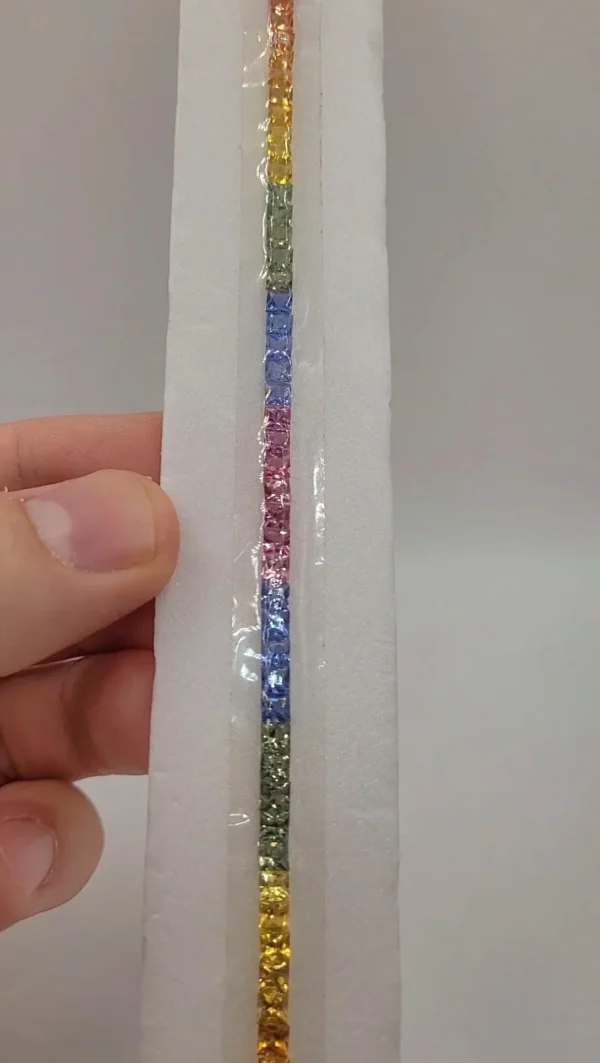 Natural rainbow sapphire suite of 51 calibrated 3.5mm stones arranged as a bracelet set, 14.5 ct total